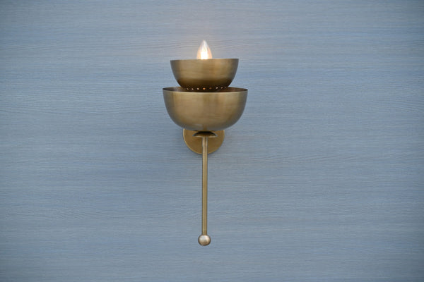 Handmade stacked bowl brass wall sconce in raw brass finish, front view, ambient modern lighting for home interiors