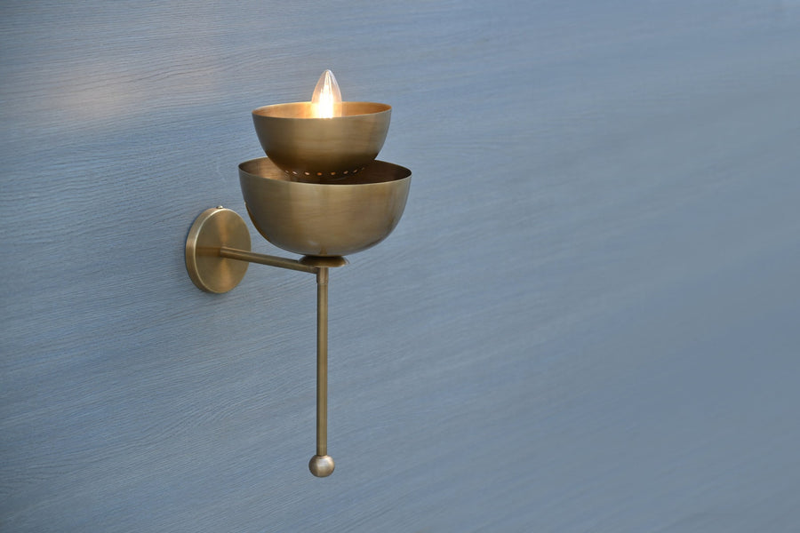 Handmade stacked bowl brass wall sconce in raw brass finish, front view, ambient modern lighting for home interiors