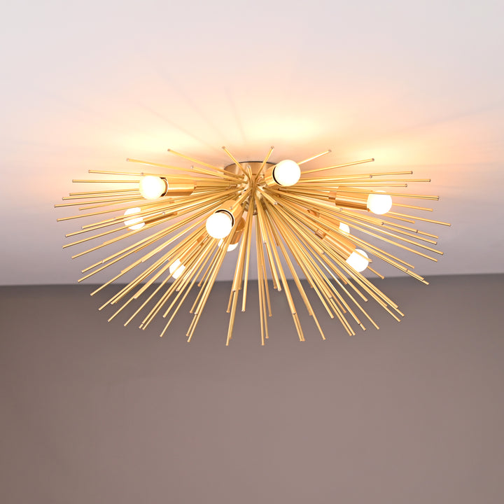 Front view of starburst flush mount chandelier with warm white bulbs and brushed brass finish