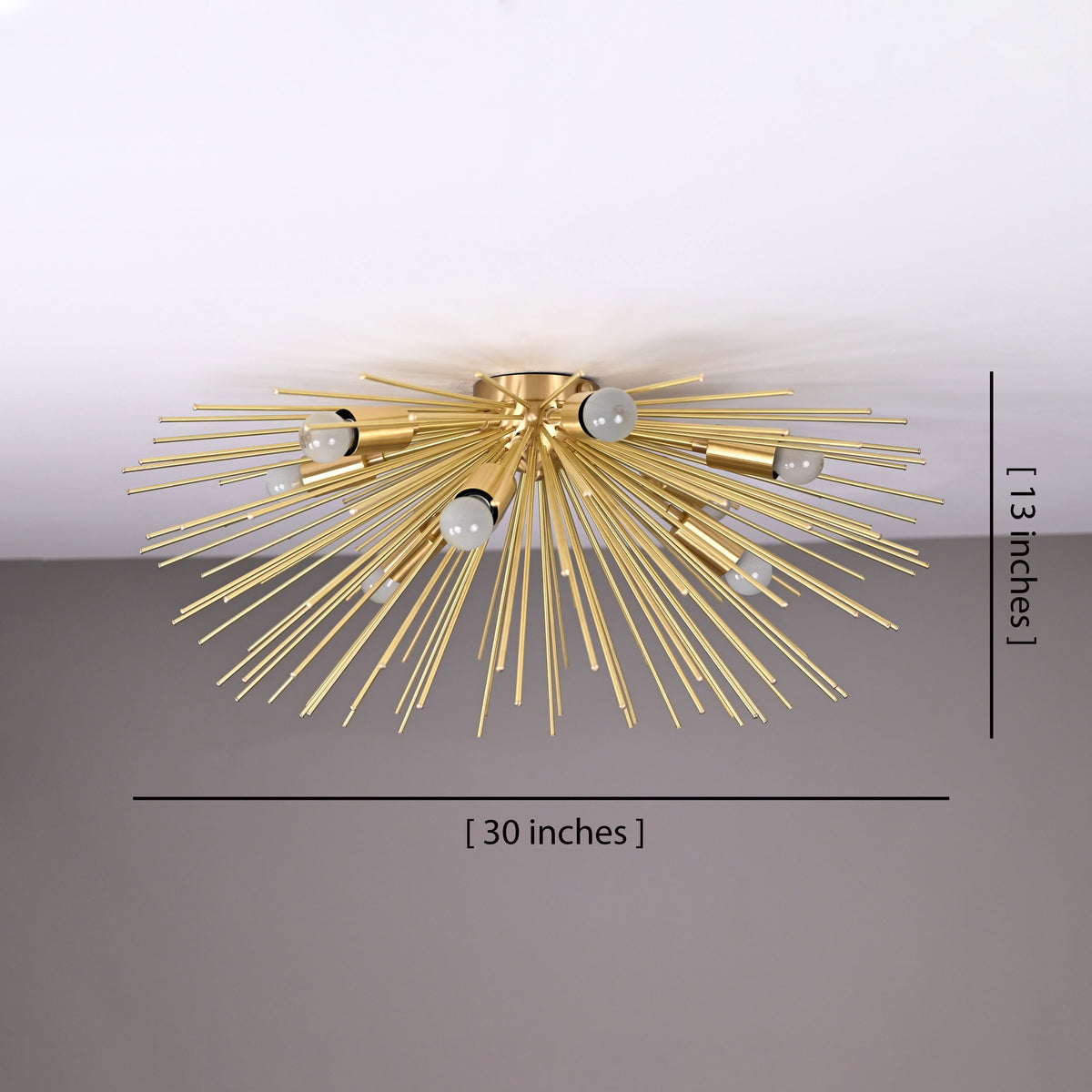 Starburst Radiance Fixture with glowing bulbs and brass rods creating elegant ceiling shadows