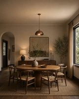 Sutton Modern Dome Pendant Light installed above a modern wooden dining table in a warm contemporary dining room – Model 33202.