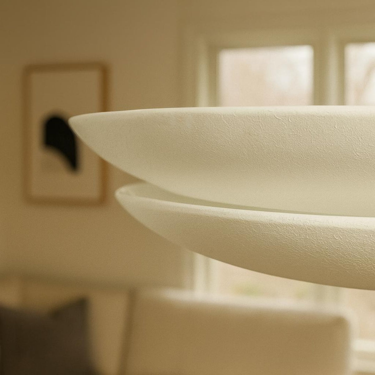 Close-up detail of textured white layered disc chandelier showcasing refined craftsmanship