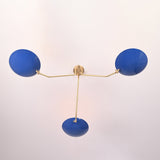 Bottom view of modern brass flush mount ceiling light highlighting three blue bowl shades