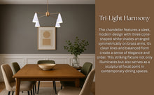 Modern brass chandelier with three cone white shades hanging above a dining table – elegant and minimalist lighting