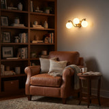 Triple globe vanity wall light with solid brass frame, round backplate, and soft diffused glass globe lighting