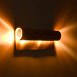 Up down wall light creating warm ambient glow above, below, and around the fixture