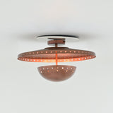 Illuminated Valencia copper ceiling light casting warm patterned shadows through decorative perforations