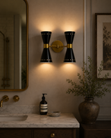 Verona perforated double cone 4 light wall sconce installed above a bathroom vanity with warm up and down lighting – Model 32793