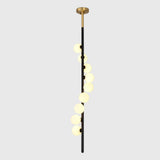 Vertical globe chandelier with cascading opal lights creating a luxury statement in a modern living room interior