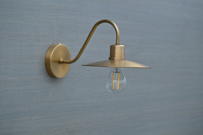 Side view of vintage brass gooseneck wall light with exposed bulb, handmade by Brass Leaf Studio in brushed satin brass finish