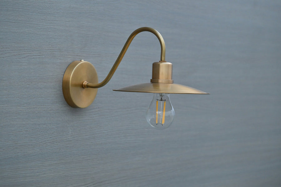 Side view of vintage brass gooseneck wall light with exposed bulb, handmade by Brass Leaf Studio in brushed satin brass finish