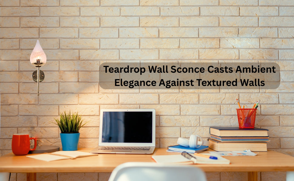 Teardrop glass brass wall sconce mounted above study desk on textured brick wall with laptop and books