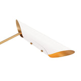 Close up of white brass cone shade with gold interior creating soft indirect ambient light