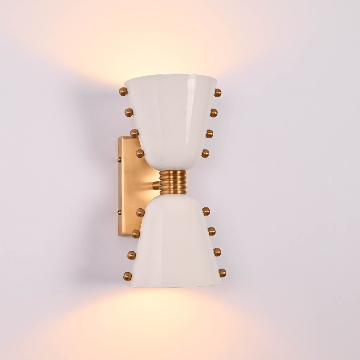 White diabolo wall light shown illuminated with soft upward and downward lighting effect
