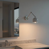 White enamel brass shade wall lamp with rounded dome design and focused warm task lighting for bedrooms or study spaces
