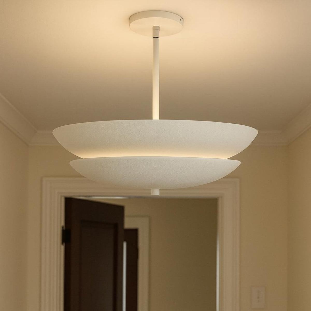 Minimalist white layered bowl ceiling pendant chandelier installed in hallway interior
