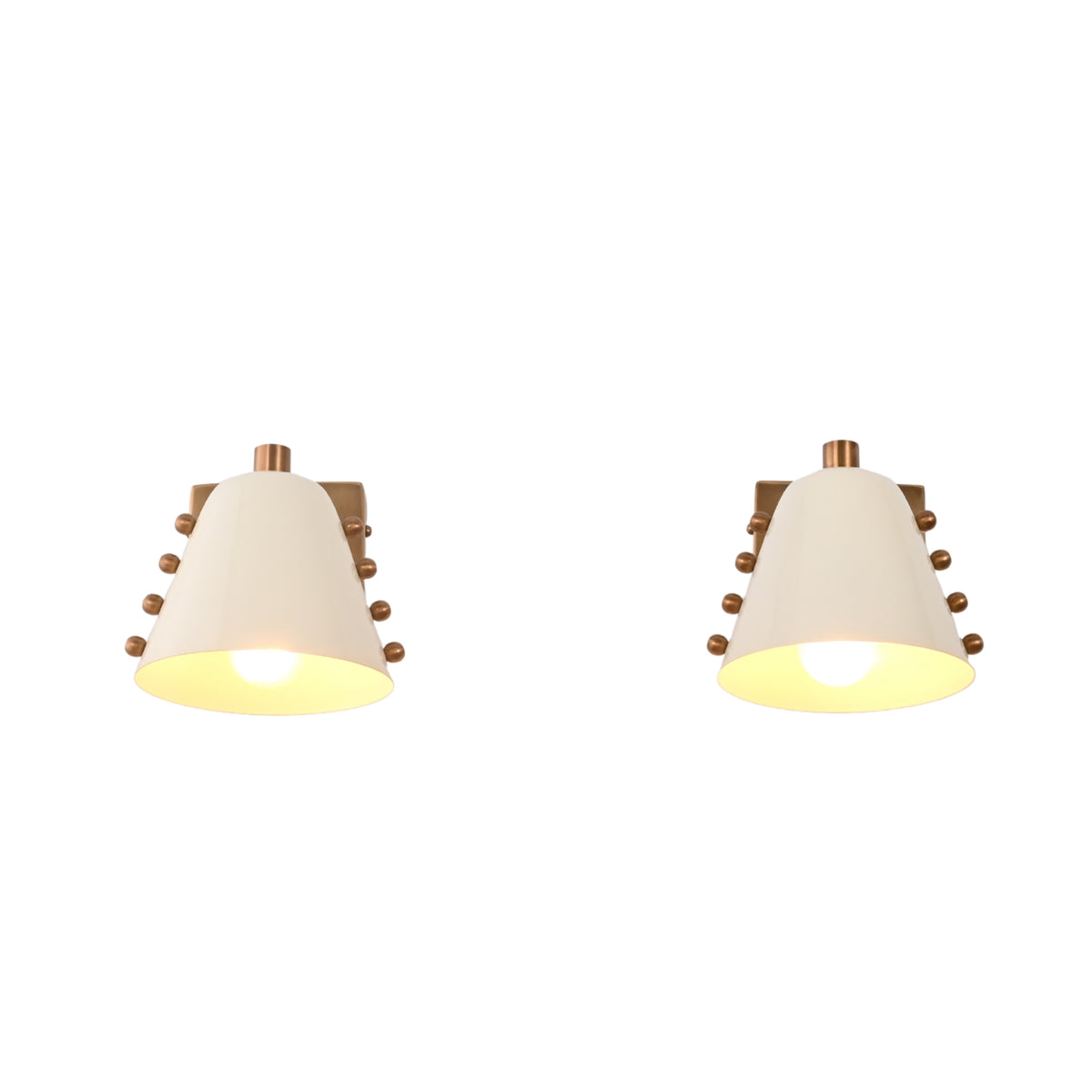 White shade wall sconce set installed beside a bed, creating soft warm lighting for a cozy bedroom