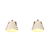 White shade wall sconce set installed beside a bed, creating soft warm lighting for a cozy bedroom