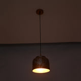 Whitewashed copper pendant light shown from front with compact rounded drum shade and warm interior glow